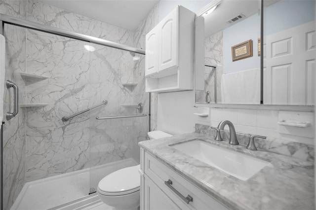 bathroom with vanity, toilet, and walk in shower