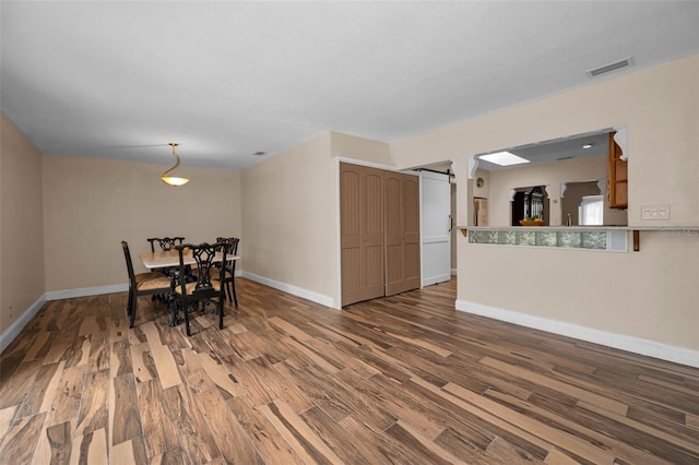 546 Orangewood Dr, Dunedin, FL 34698 - dining area featuring wood finished floors and baseboards
