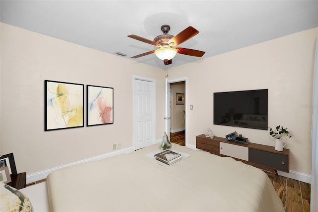 546 Orangewood Dr, Dunedin, FL 34698 - bedroom with wood finished floors, baseboards, a ceiling fan, and a closet