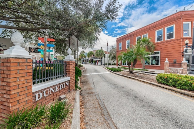 546 Orangewood Dr, Dunedin, FL 34698 - view of asphalt street featuring sidewalks, curbs, traffic signs, and street lights