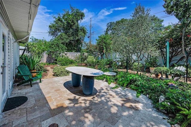 546 Orangewood Dr, Dunedin, FL 34698 - fenced backyard featuring a patio area
