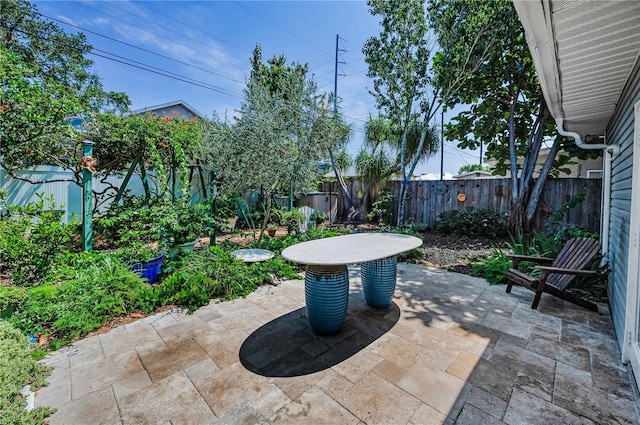 546 Orangewood Dr, Dunedin, FL 34698 - fenced backyard featuring a patio