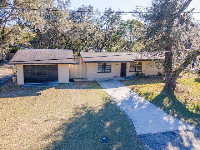 ranch-style home featuring a garage and a front yard