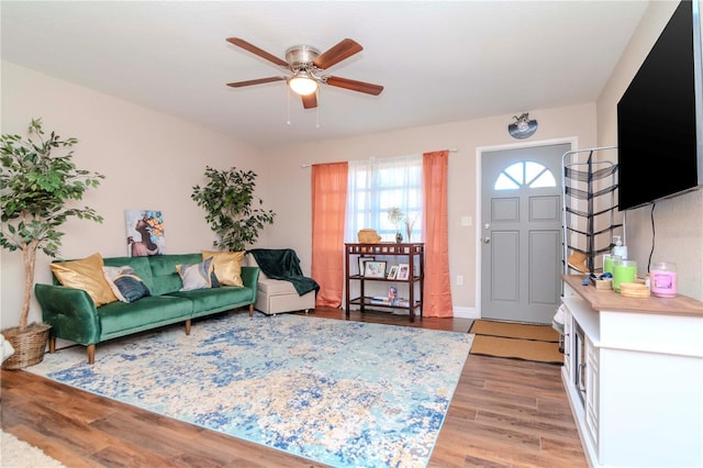 living room featuring hardwood / wood-style floors and ceiling fan