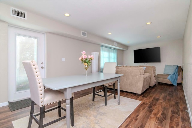 dining space featuring dark hardwood / wood-style flooring and a wealth of natural light