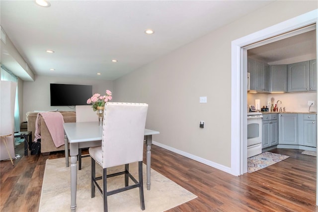 dining area with dark hardwood / wood-style flooring and sink