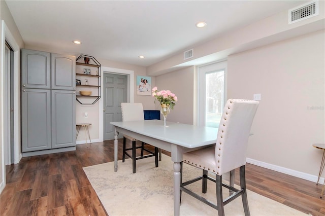 dining space with dark hardwood / wood-style flooring