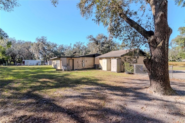 view of yard featuring a storage unit and central AC unit