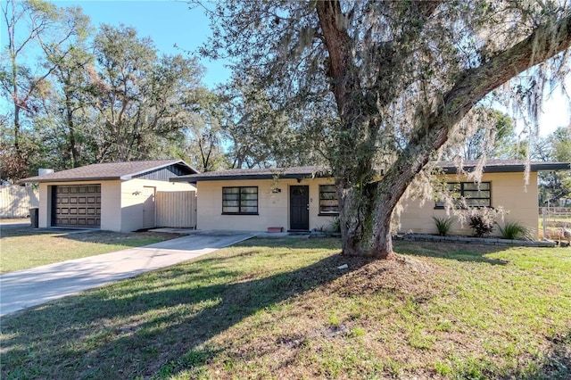 ranch-style home with a garage and a front yard