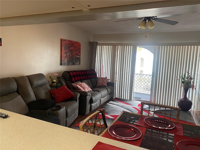 living room with ceiling fan and carpet