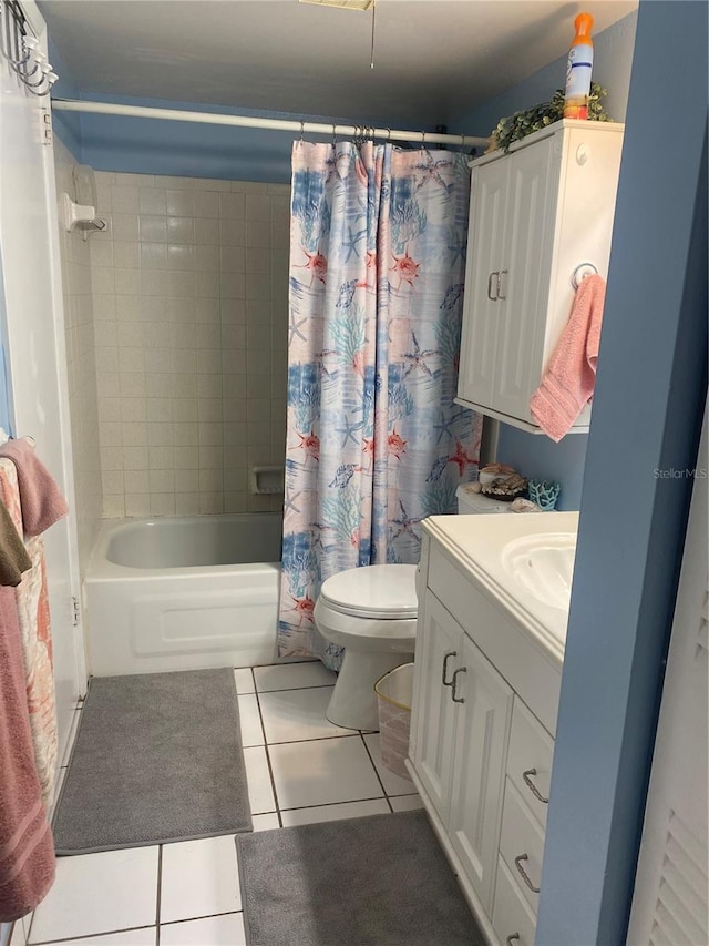 full bathroom with tile patterned floors, toilet, shower / bath combo with shower curtain, and vanity