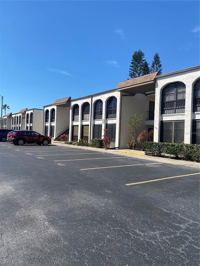 view of building exterior featuring uncovered parking