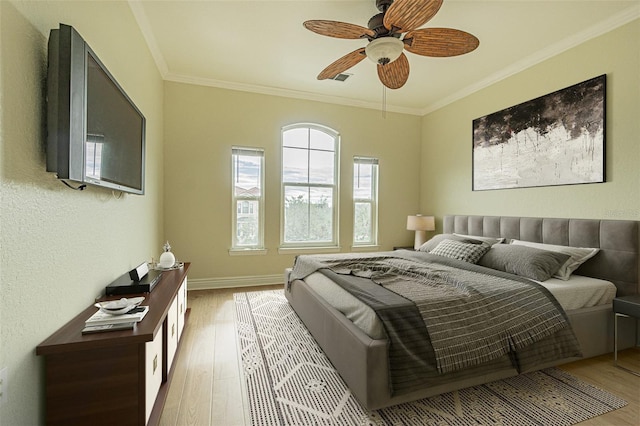 bedroom with ceiling fan, light hardwood / wood-style flooring, and ornamental molding