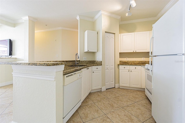 kitchen with white appliances, white cabinets, sink, kitchen peninsula, and dark stone counters