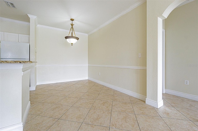 empty room with crown molding and light tile patterned flooring