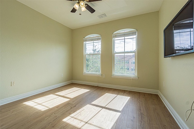 unfurnished room featuring ceiling fan and hardwood / wood-style floors