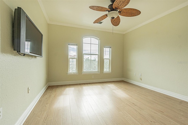 empty room featuring ceiling fan, light hardwood / wood-style flooring, and ornamental molding