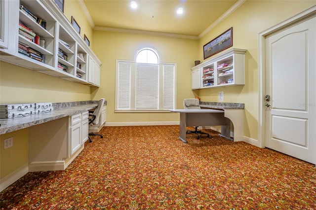 carpeted home office with ornamental molding and built in desk