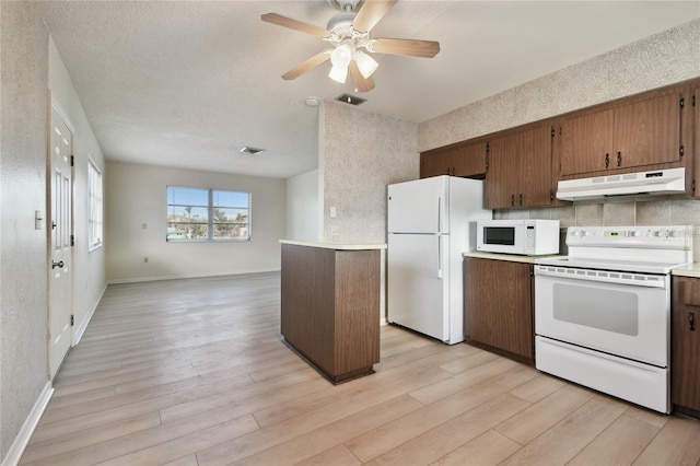 kitchen featuring light hardwood / wood-style floors, white appliances, a textured ceiling, and ceiling fan