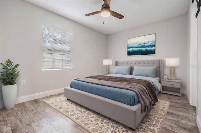 bedroom featuring light wood-type flooring and ceiling fan