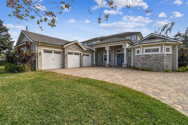 view of front of property featuring a garage and a front lawn