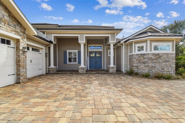 view of exterior entry with a garage