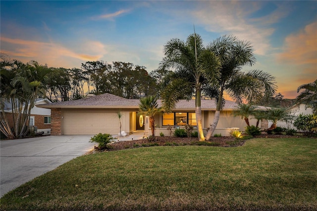 single story home featuring a yard and a garage