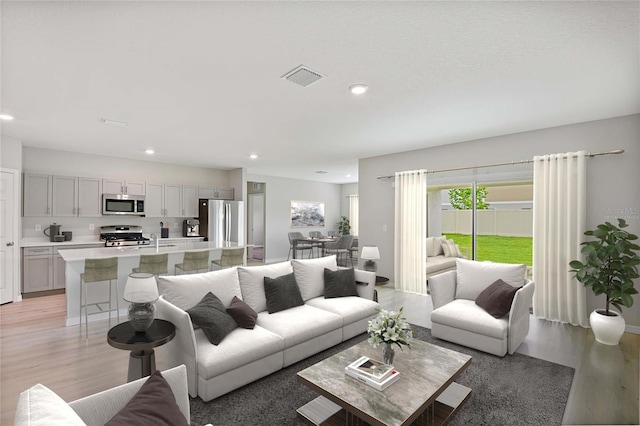 living room with sink and light hardwood / wood-style floors