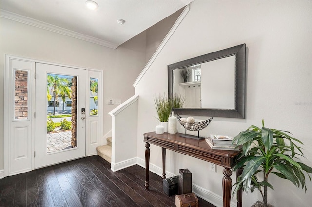 entryway with ornamental molding and dark hardwood / wood-style flooring