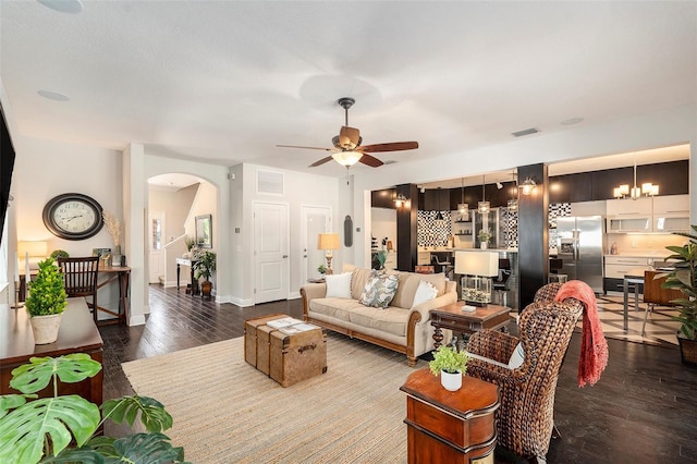 living room featuring hardwood / wood-style flooring and ceiling fan with notable chandelier