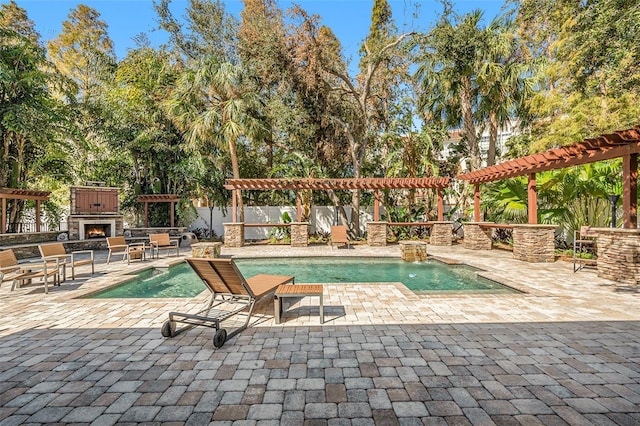 view of pool with a patio, an outdoor fireplace, and a pergola