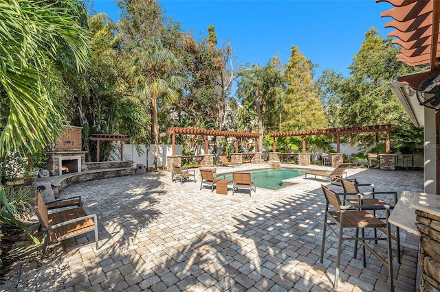 view of patio with a fenced in pool, an outdoor stone fireplace, and a pergola