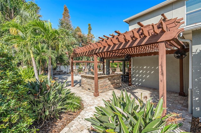 view of patio with an outdoor bar and a pergola