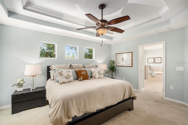 carpeted bedroom featuring ceiling fan, a tray ceiling, and ornamental molding