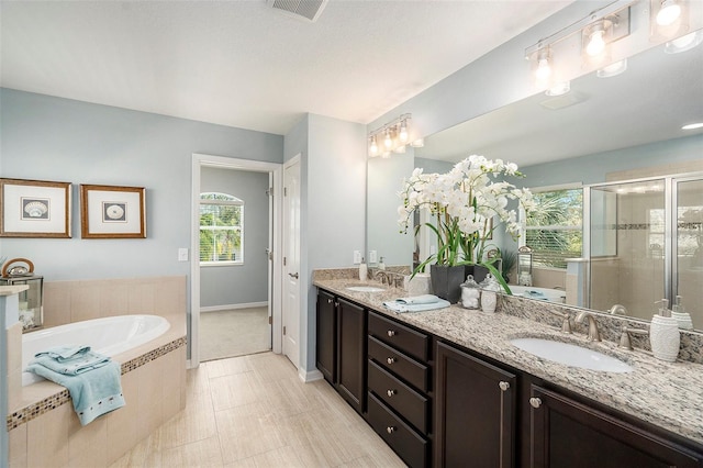 bathroom featuring vanity and plus walk in shower