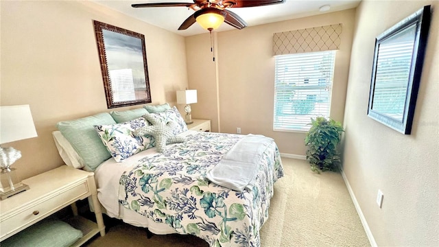 bedroom with multiple windows, light colored carpet, and ceiling fan