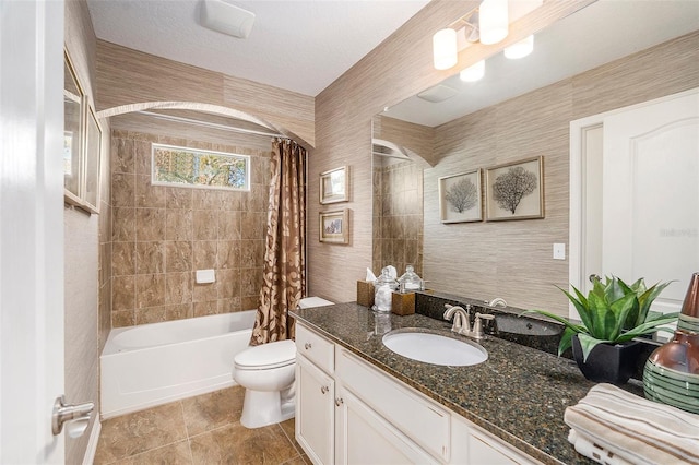 full bathroom featuring toilet, shower / bath combo with shower curtain, a textured ceiling, tile patterned flooring, and vanity