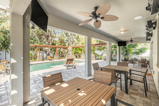 5701 S Macdill Ave, Tampa, FL 33611 - fenced backyard featuring outdoor dining area, ceiling fan, a patio, and an outdoor pool