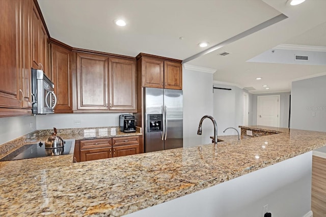 450 Knights Run Ave Unit 605, Tampa, FL 33602 - kitchen with light stone countertops, stainless steel appliances, and kitchen peninsula