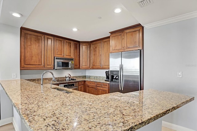 450 Knights Run Ave Unit 605, Tampa, FL 33602 - kitchen featuring sink, light stone counters, ornamental molding, appliances with stainless steel finishes, and kitchen peninsula