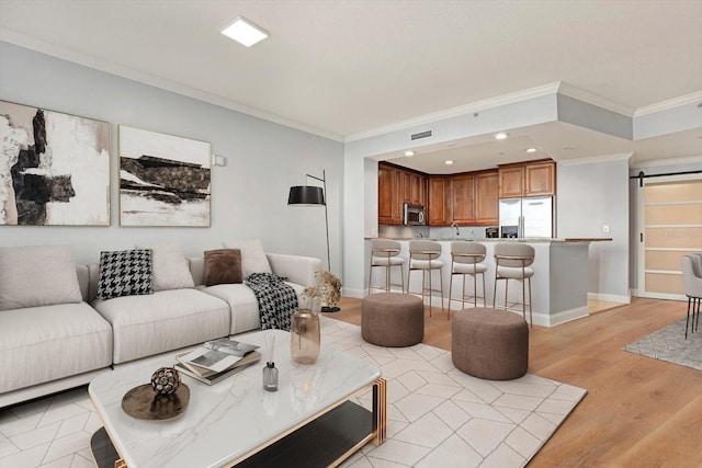 450 Knights Run Ave Unit 605, Tampa, FL 33602 - living room featuring sink, ornamental molding, a barn door, and light wood-type flooring