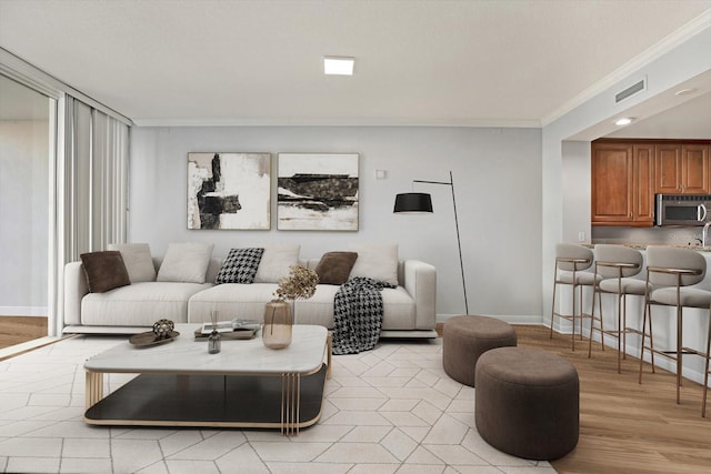 450 Knights Run Ave Unit 605, Tampa, FL 33602 - living room with crown molding and light hardwood / wood-style floors