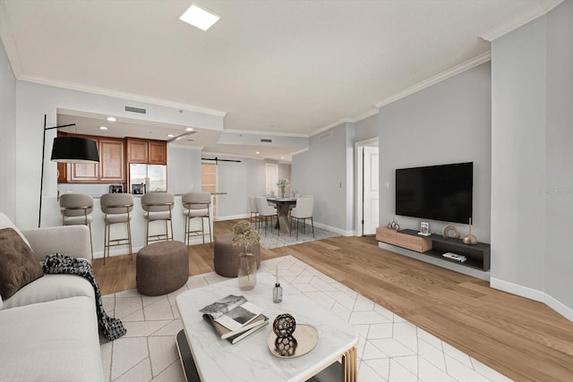 450 Knights Run Ave Unit 605, Tampa, FL 33602 - living room featuring ornamental molding, a barn door, and light hardwood / wood-style flooring
