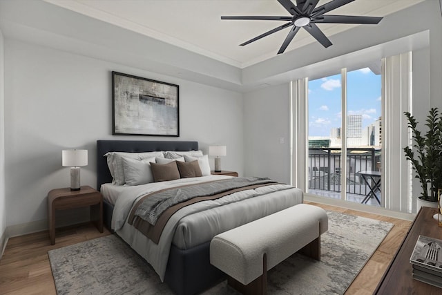 450 Knights Run Ave Unit 605, Tampa, FL 33602 - bedroom featuring crown molding, ceiling fan, hardwood / wood-style floors, a tray ceiling, and access to outside