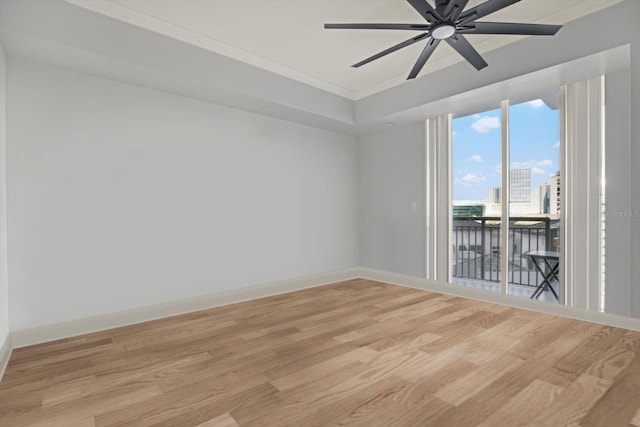 450 Knights Run Ave Unit 605, Tampa, FL 33602 - unfurnished room featuring ornamental molding, ceiling fan, light hardwood / wood-style floors, and a tray ceiling