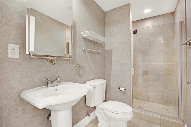 450 Knights Run Ave Unit 605, Tampa, FL 33602 - bathroom featuring sink, toilet, an enclosed shower, and tile patterned flooring