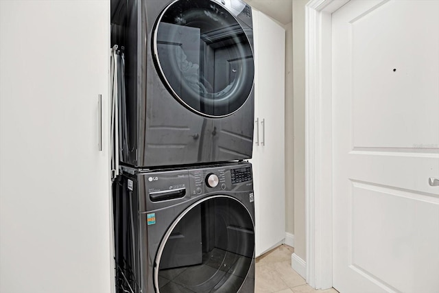 450 Knights Run Ave Unit 605, Tampa, FL 33602 - laundry area featuring stacked washer / dryer and light tile patterned flooring