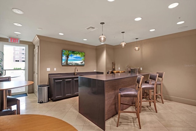 450 Knights Run Ave Unit 605, Tampa, FL 33602 - bar featuring crown molding, decorative light fixtures, dark brown cabinets, and light tile patterned flooring