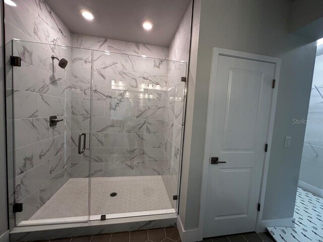 full bath featuring recessed lighting, a shower stall, baseboards, and tile patterned floors