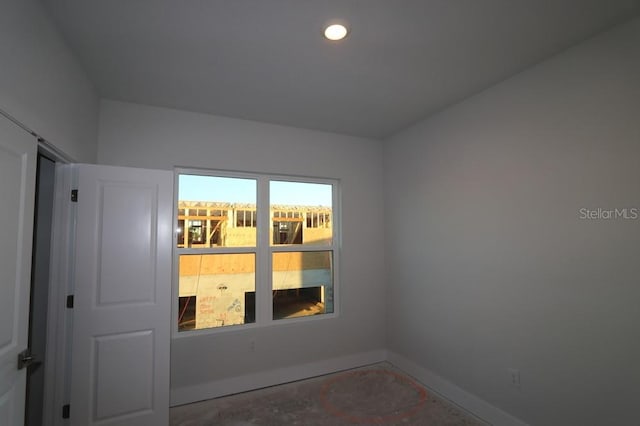 unfurnished room featuring baseboards